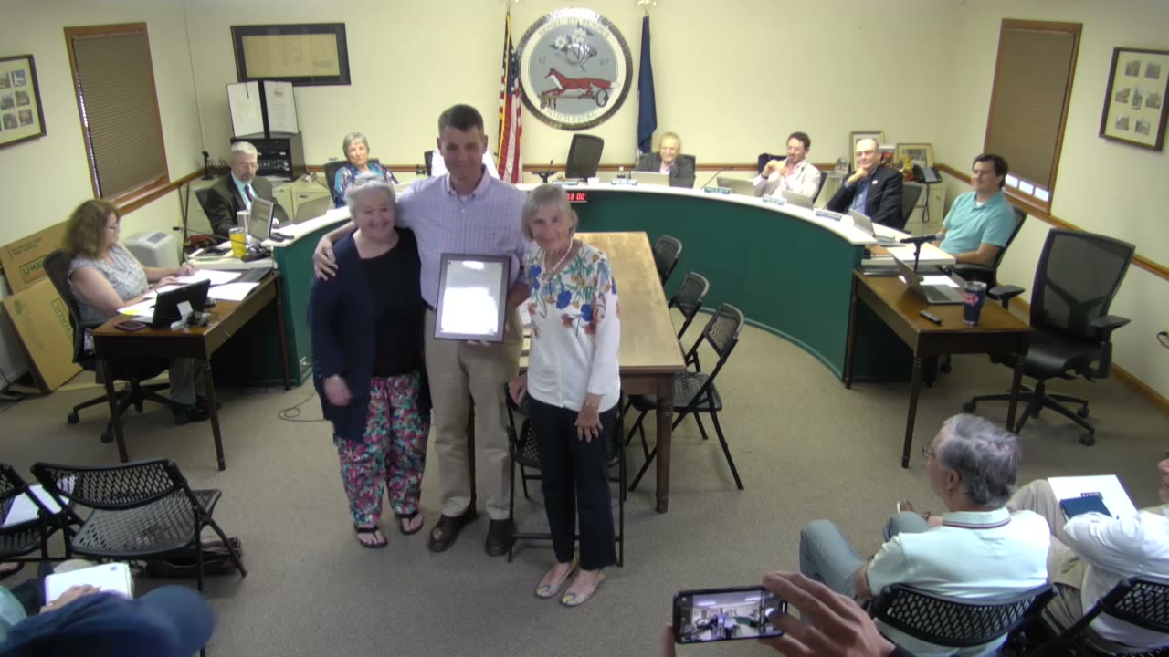 Betsy Allen Davis, left, and Page Allen with Mayor Bridge Littleton and Council's resolution honoring The Fun Shop, July 13, 2023. (Town of Middleburg meeting video)